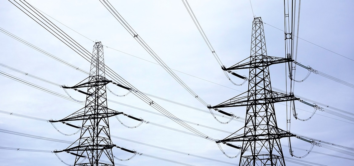 power grids and electrick wires seen across the blue sky
