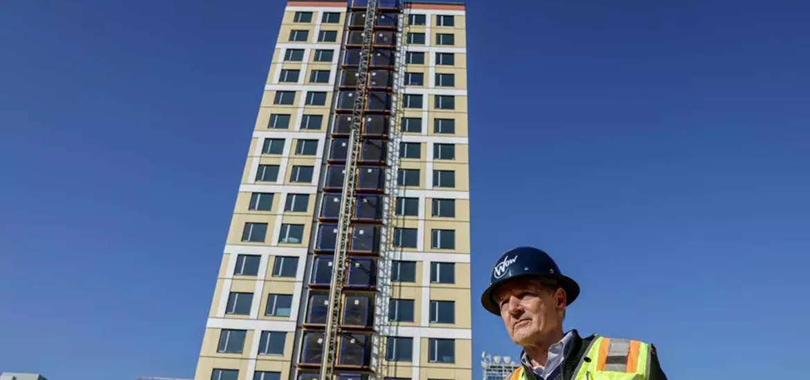 Andy Ball, who is the head of construction of real estate developer oWow stands for a portrait in front of a 18-story residential building on Harrison Street in Oakland