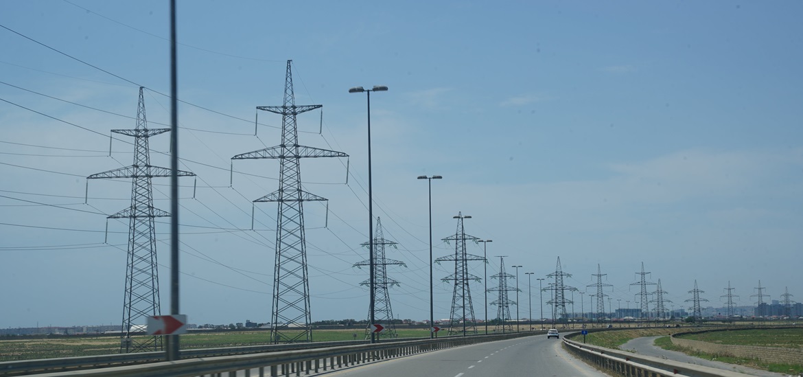 High Voltage Lines Along Empty Road