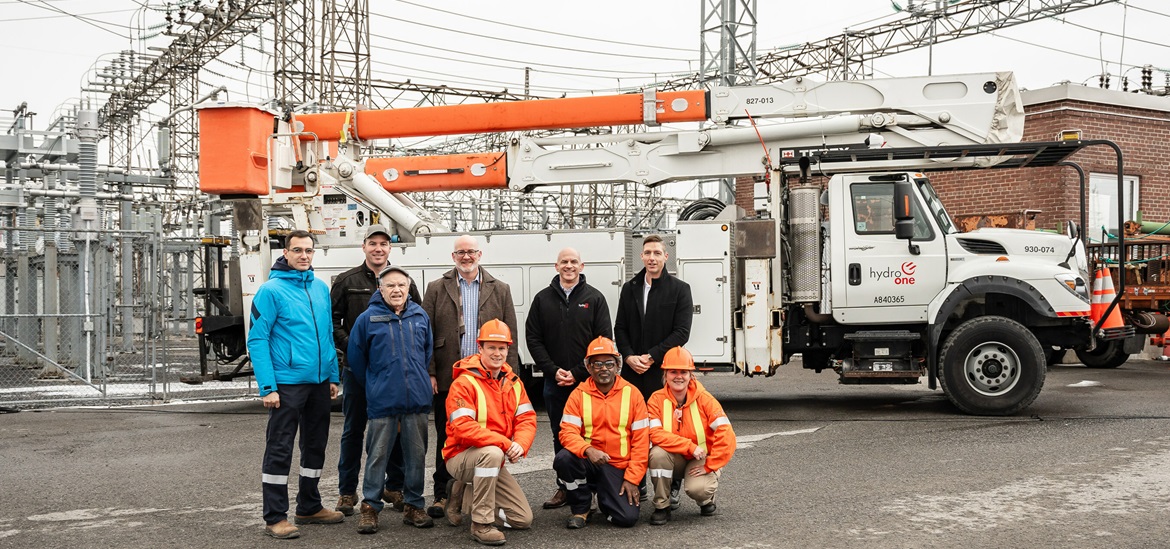 Hydro One joined by officials from Hydro Ottawa, the City of Ottawa and the local community association standing in front of a truck with a crane