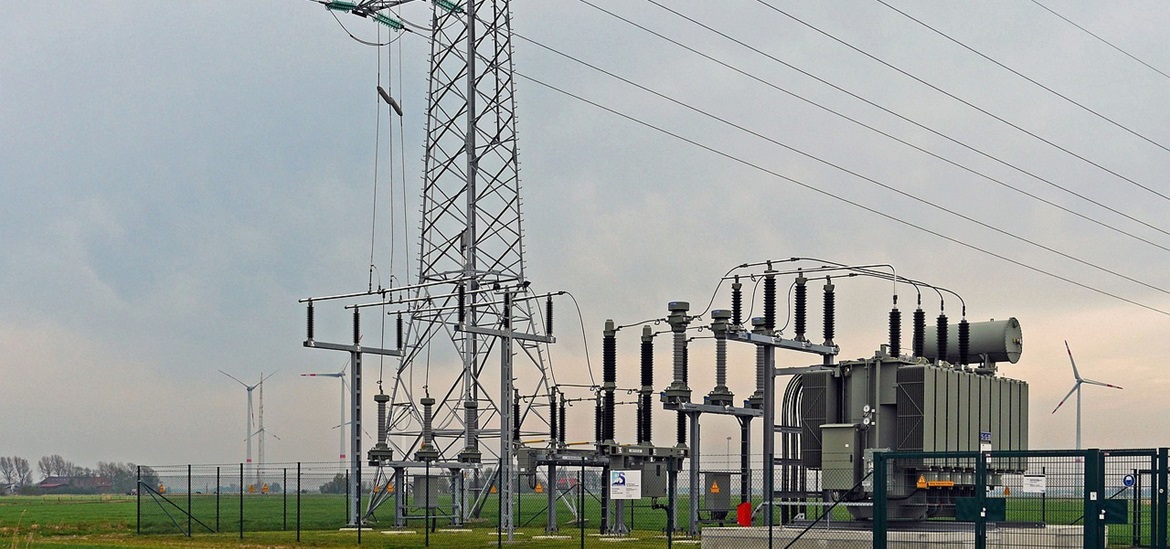 power transformer substation on the field surrounded by the fence