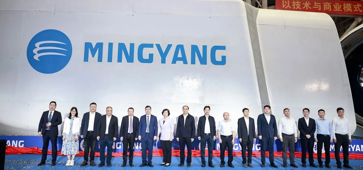 Mingyang wind turbine presenting on the stage- with delegation members from Mingyang standing in front
