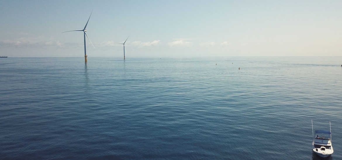 Offshore wind mills, sea and a boat