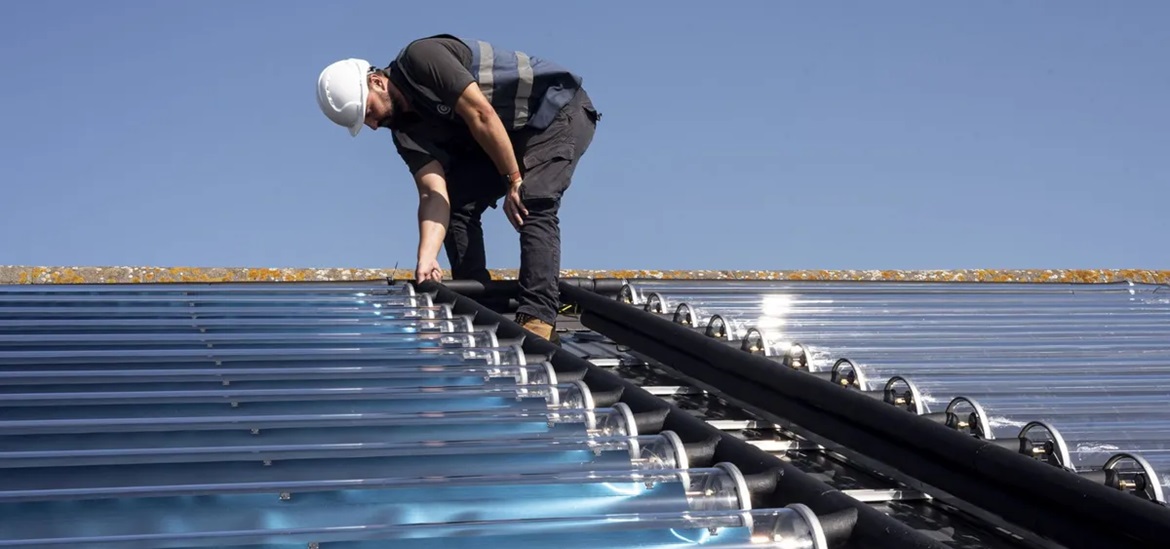 construction worker on a solar panel covered roof