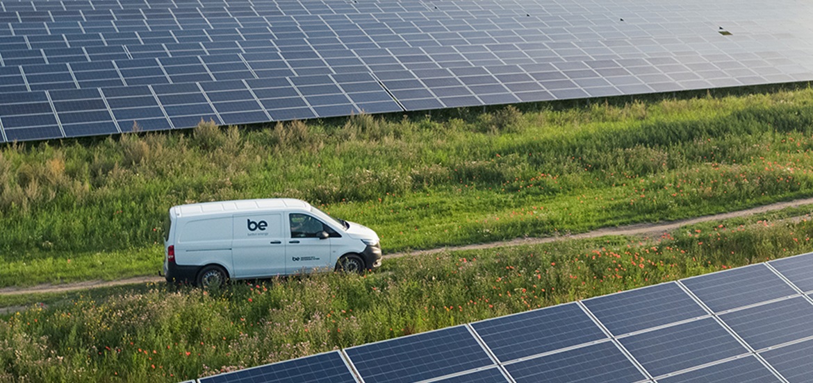 Better Energy van driving in the field road between 2 solar plants 