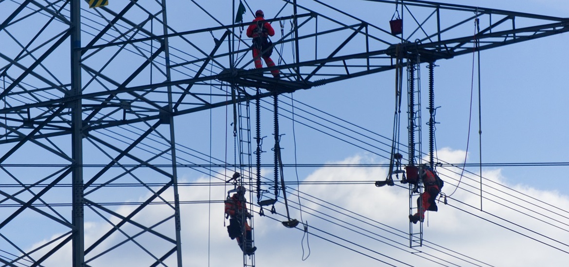 Maintenance workers at the top of a power tower