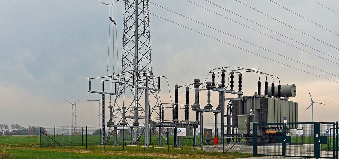 Power transformer substation connected to the grid, surrounded by a fence