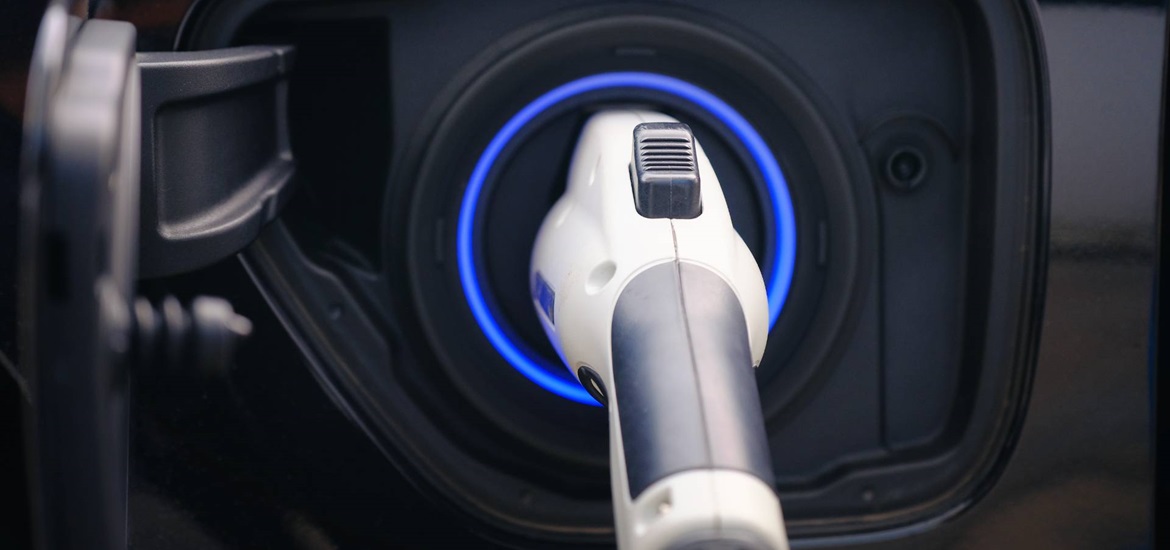 Close up of EV Charger inserted in a car charging compartment