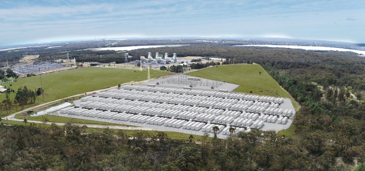 Energy storage facility, with rows and rows of batteries surrounded by green field and woods, taken from bird perspective