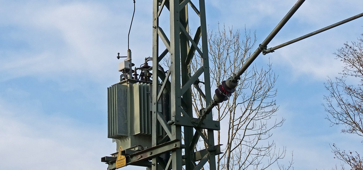power transformer on a utility pole connected to power lines