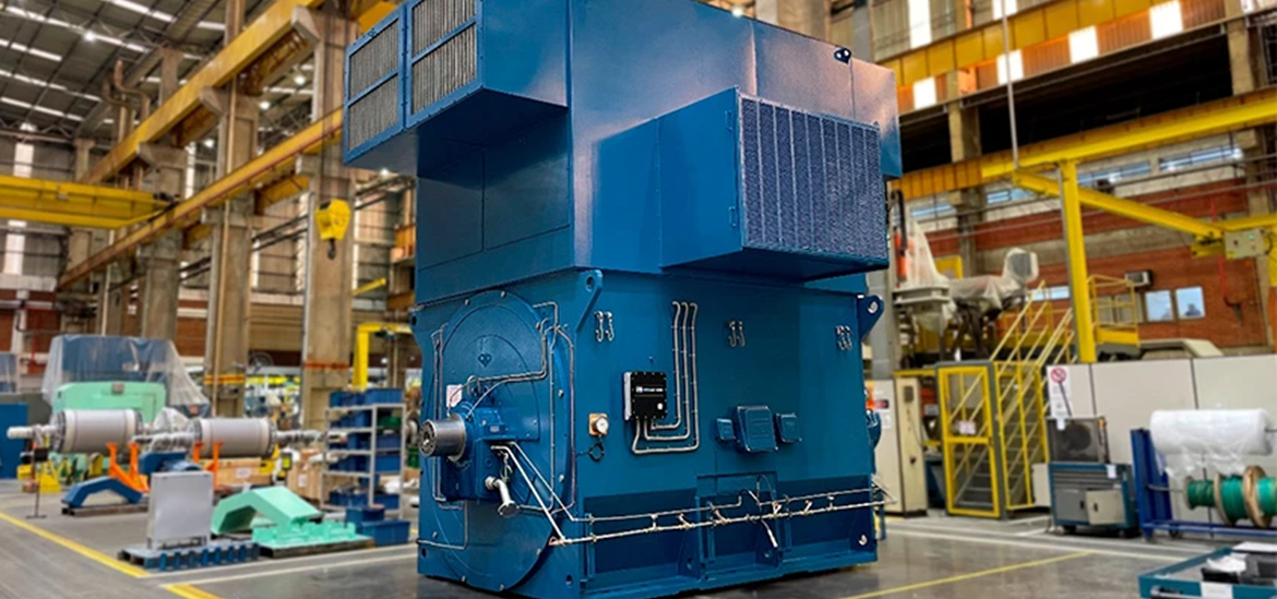 Photo of a synchronous condenser system (a big blue container) in a storage 