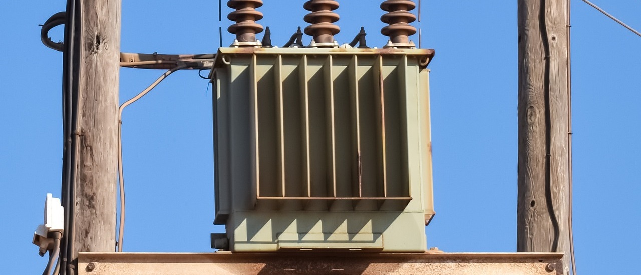 power transformer attached to a wooden pole