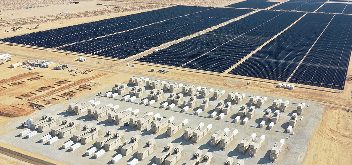 solar panels and energy storage containers across the desert ground