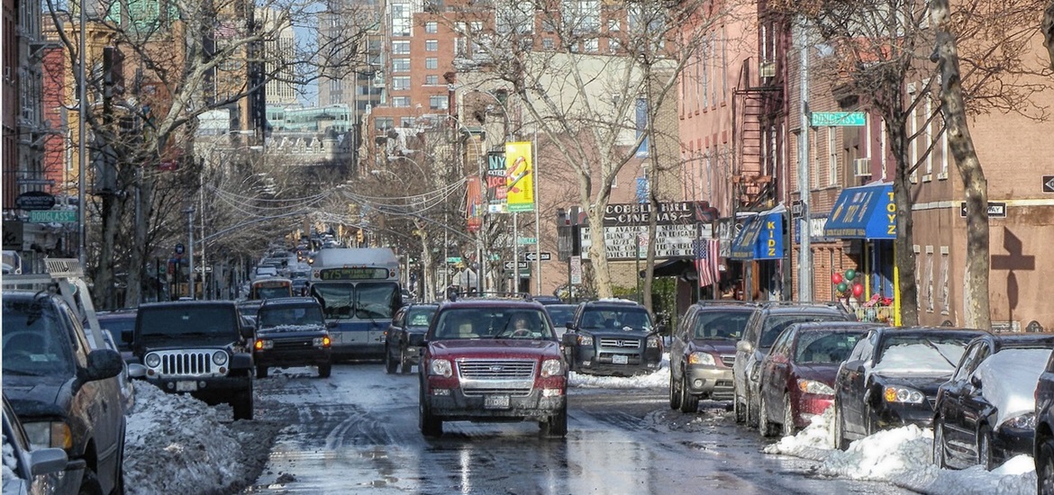 Brooklyn street with pavements and parked cars covered in snow