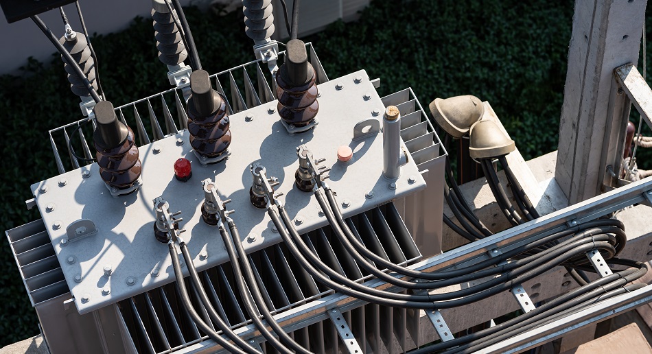 Top view of High voltage power transformer with electrical insulation and electrical equipment in power substation.