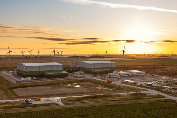 Wind farm and storage facilities in the field in the sunset 
